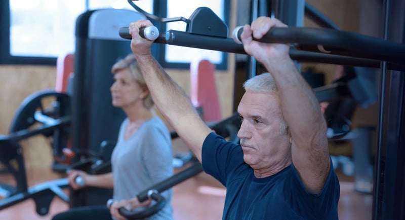 An older couple training on gym equipment